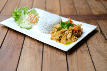 stir fried chicken curry sauce serving with rice and vegetable