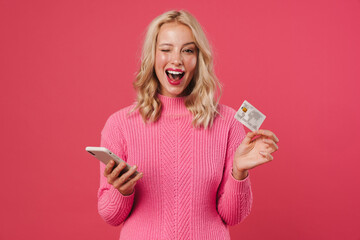 Image ofl woman winking while holding mobile phone and credit card