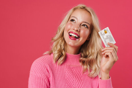 Image of cheerful blonde woman smiling while posing with credit card
