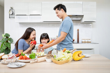 Asian family enjoy playing and cooking food in kitchen at home - 379593625