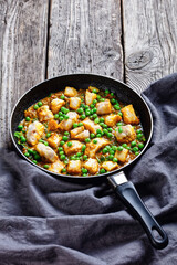 fish curry with green peas, top view
