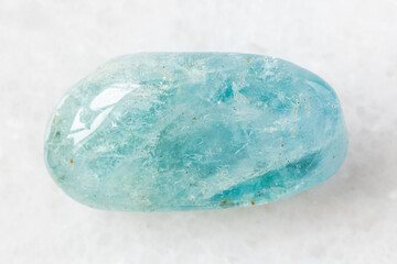 closeup of sample of natural mineral from geological collection - tumbled Aquamarine (blue Beryl)...