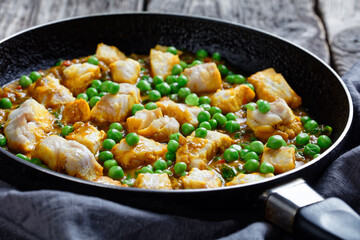 fish curry with green peas, top view