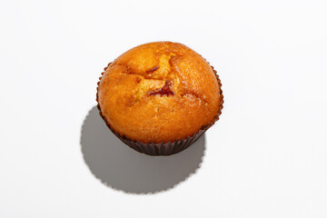 Dessert, sweets and fast food takeaway during covid-19 quarantine. Appetizing cupcake with jam in brown paper with shadow