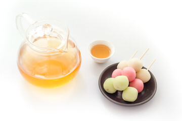 Japanese tea and sweet dumplings Dango on plate, close up