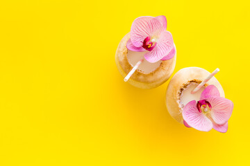 Coconut drink with drinking straw, top view