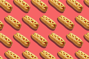 Fast food for company. Appetizing hot dogs with sausage and mustard on pink background