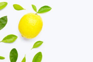 Fresh lemon with green leaves on white.