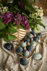 Obraz na płótnie Canvas Easter eggs on the table, decorated with lilacs. 