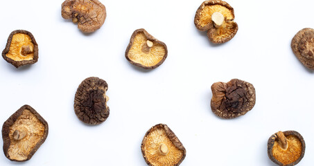 Dried shiitake mushrooms on white background.