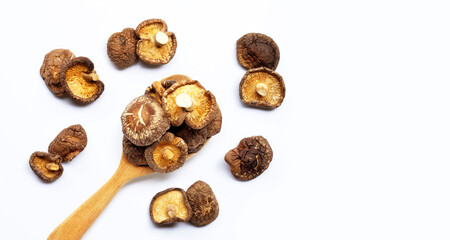 Dried shiitake mushrooms on white background.