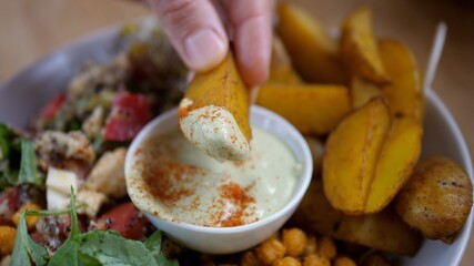 Close up of plate with healthy organic homemade food. Chickpea salad served with potato wings 