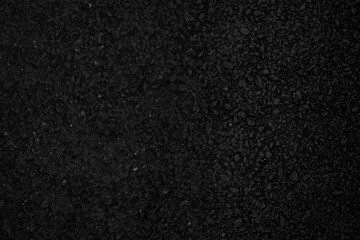 Rough-textured black asphalt surface and background