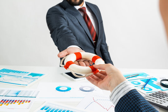 Business Persons Holding Small Lifebuoy Together