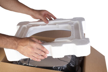 Packing goods in cardboard box with styrofoam material for safe transportation of cargo. Isolated...