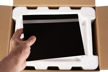 Packing goods in cardboard box with styrofoam material for safe transportation of cargo. Isolated...