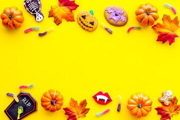 Halloween background concept - gingerbread cookies and candies, top view