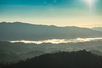 Beautiful Landscape of mountain layer in morning sun ray and winter fog at Doi Hua Mae Kham, Mae Salong Nai, Chiangrai, Thailand