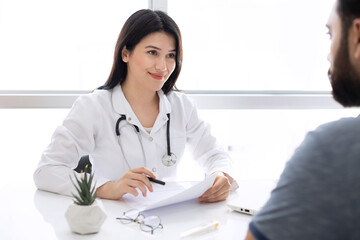 Beautiful female doctor consulting patient