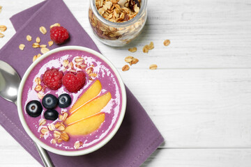 Delicious acai smoothie served on white wooden table, flat lay. Space for text