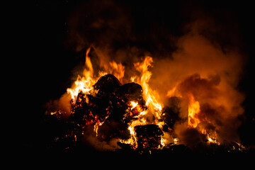 Hot red burning large fire with the black starry night sky.