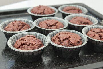 Chocolate cupcakes on the baking sheet