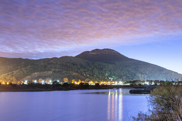 night scene of landscape reflected in lagoon