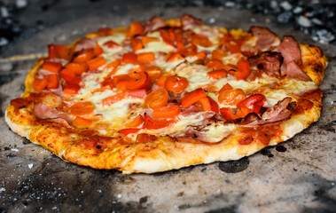 Making of homemade Italian pizza in fireplace brick oven.