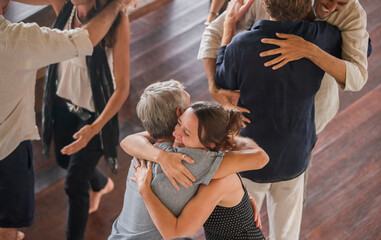 Diverse group of multiethnic people embracing and giving hugs to each other. Support, friendship...