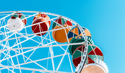 Ferris wheel on the background of blue sky