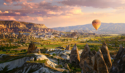 Colorful hot air balloon fly over valley volcanic mountains in Goreme national park,Turkey - obrazy, fototapety, plakaty