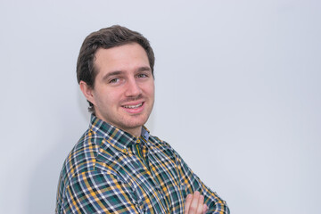 Fototapeta premium Photo of a young and attractive man wearing a shirt smiling at the camera looking very professional. Casual business man, corporative.