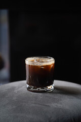 Coffee in glass cup on dark background