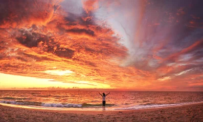 Rolgordijnen View of a happy woman on the sunset beach © denis_333