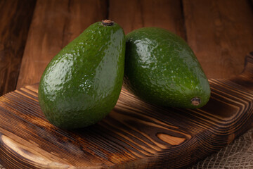 Eco vegetables - fresh avocado on wooden background, vegan food