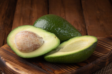 Eco vegetables - fresh avocado on wooden background, vegan food
