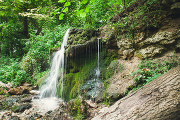 Fototapeta na wymiar Waterfall in the summer forest. Eco trail in Pushchino on the Oka. Moscow region