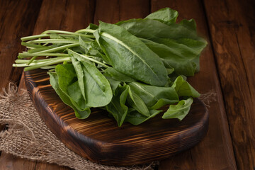 Eco vegetables - fresh green spinach on wooden background, vegan food