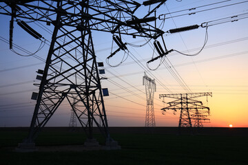 high voltage pylons in the evening