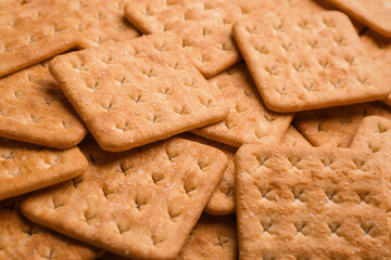 Many delicious crackers as background, closeup view