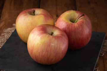 Eco fruits - fresh red apples on wooden background, vegan food