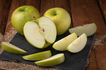 Eco fruits - fresh green apples on wooden background, vegan food