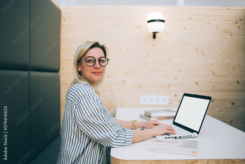 Aufkleber portrait of smart casual woman in optical eyewear for vision protection sitting at desktop table wit