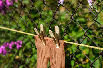 Thin women's socks are attached with clothespins.