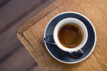 A cup of coffee on a wooden table