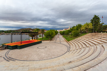 Urban landscape of the city of Mirandela in the north of Portugal. Panoramic view of the banks of the river Tua with the traditional Roman bridge and the historic center with its church tower.