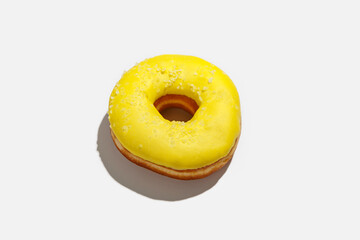 Bright sweets and fast takeaway food. Yummy donut with yellow glaze and white powder is order for home during covid-19 pandemic