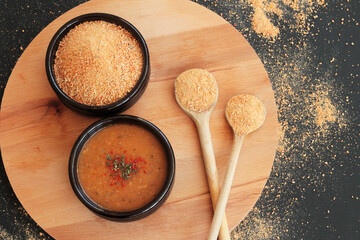 Traditional Turkish Homemade Dry Soup,Tarhana grains and cooked in casserole bowl on wooden tray with wooden spoons