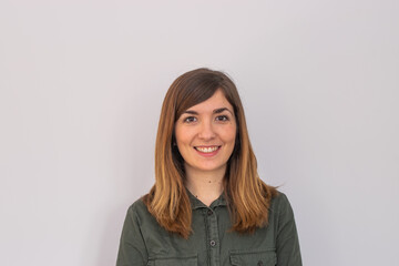 Photo of a young and attractive woman looking corporative with a shirt smiling at the camera,...