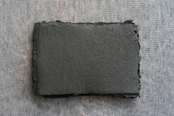 A set of handmade paper sheets lies on a gray surface. Paper recycling and zero waste concept.